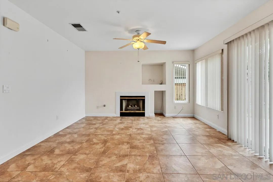 117 Willow Pond Road Santee, CA 92071 - Photo 18 of 49 a view of an empty room with a fireplace and a window
