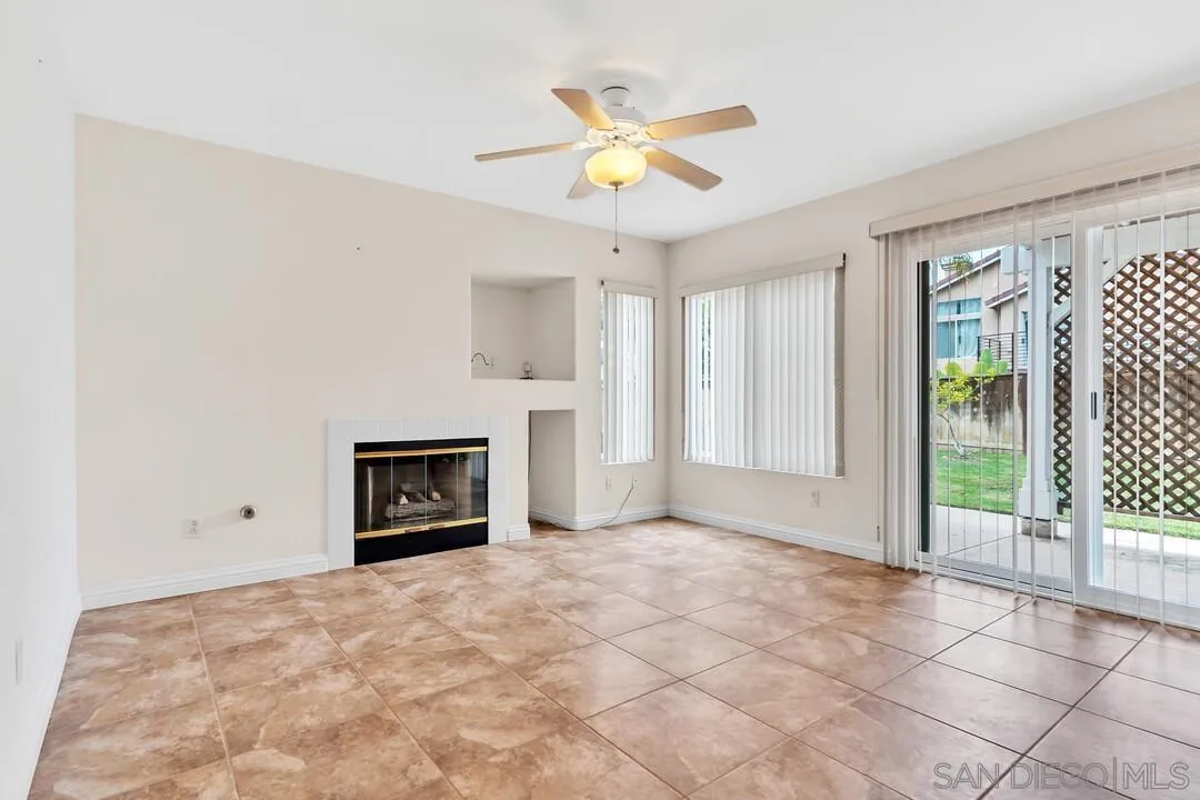 117 Willow Pond Road Santee, CA 92071 - Photo 19 of 49 a view of an empty room with a fireplace and a window