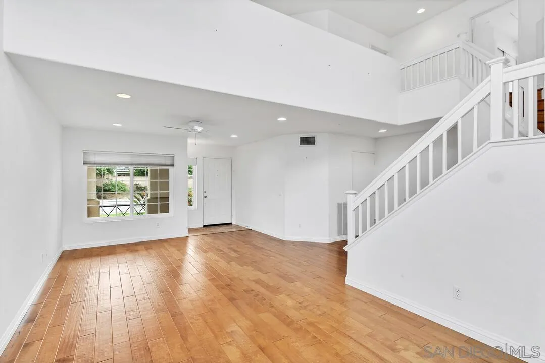 117 Willow Pond Road Santee, CA 92071 - Photo 7 of 49 a view of an empty room with wooden floor and windows