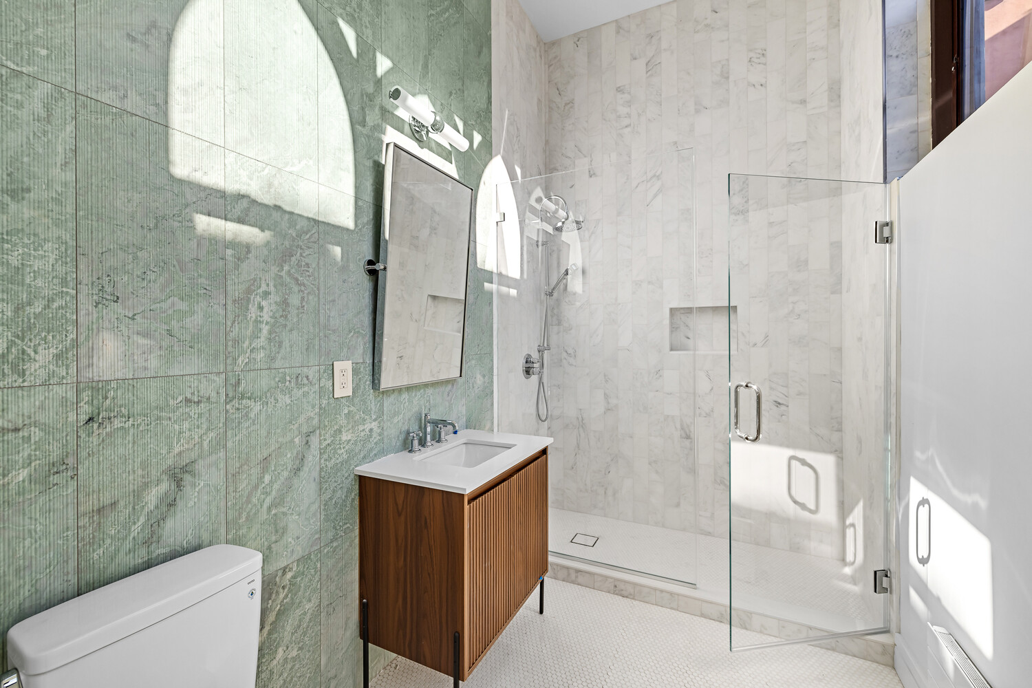 232 Adelphi Street, Unit 4 Brooklyn, NY 11205 - Photo 11 of 15 a bathroom with a double vanity sink toilet and shower