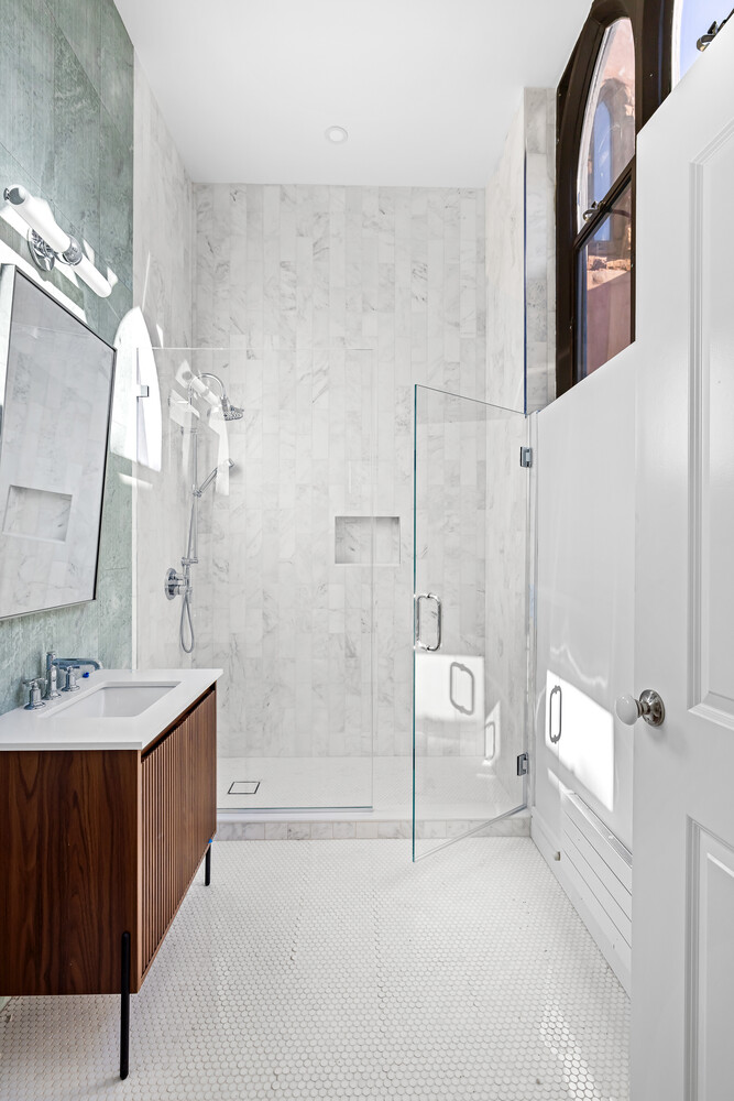 232 Adelphi Street, Unit 4 Brooklyn, NY 11205 - Photo 12 of 15 a spacious bathroom with a tub sink mirror and a shower