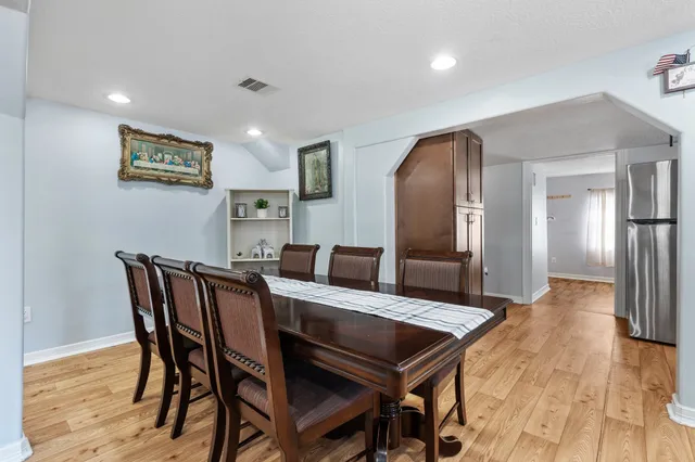 a view of a dining room with furniture and wooden floor