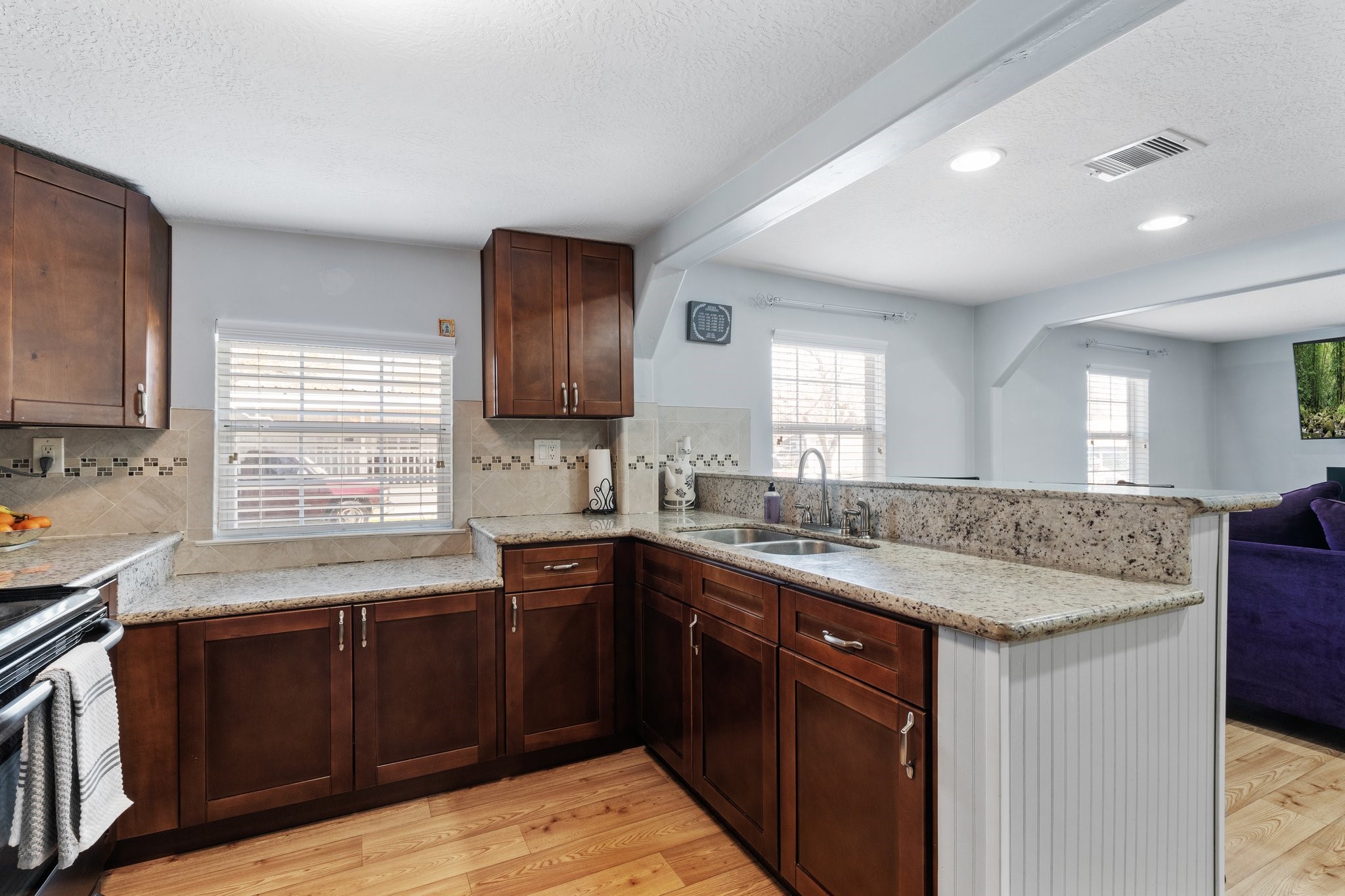 230 Busch Street Houston, TX 77060 - Photo 17 of 34 a kitchen with granite countertop sink stove and cabinets