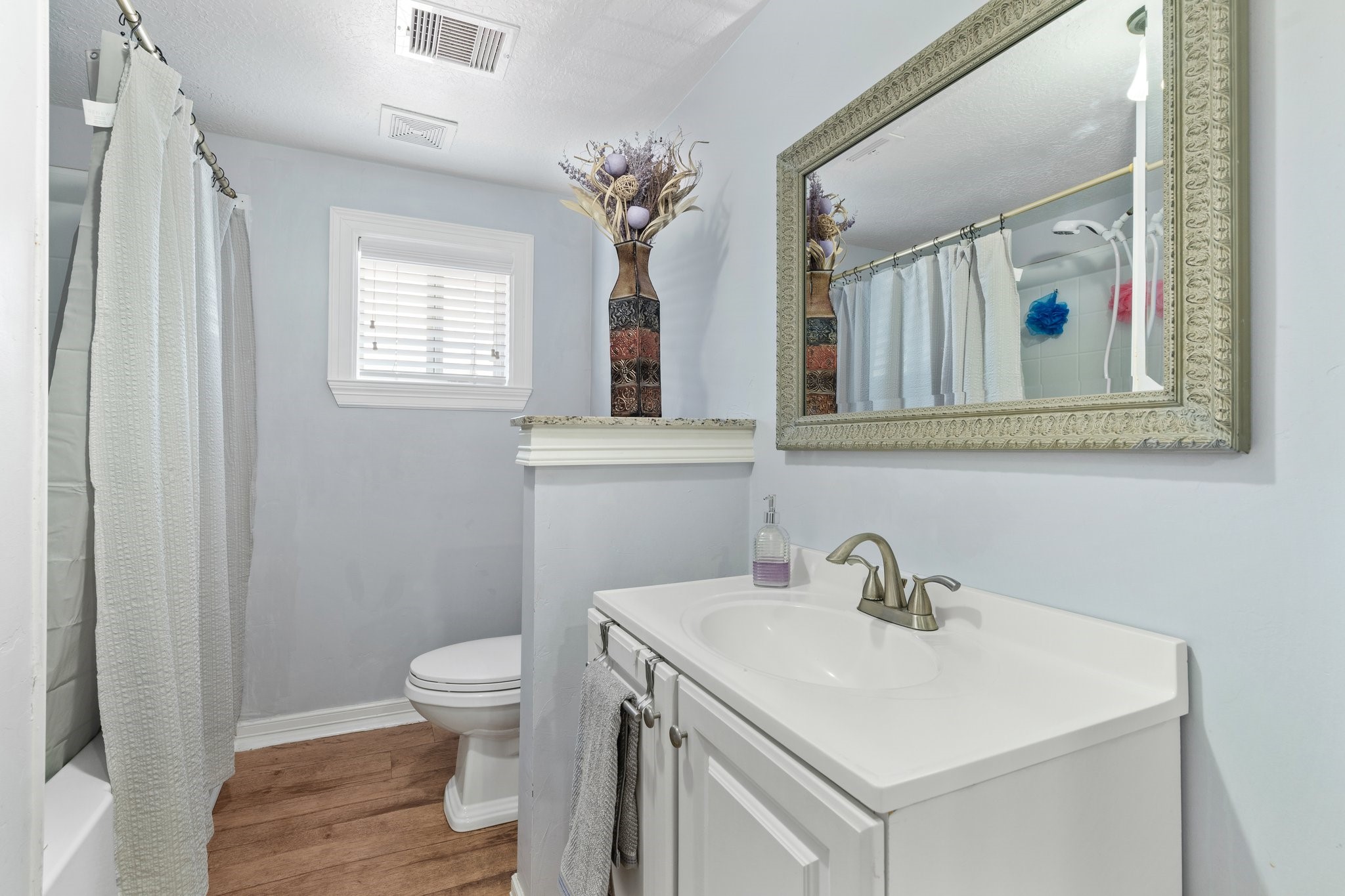 230 Busch Street Houston, TX 77060 - Photo 25 of 34 a bathroom with a toilet sink and mirror