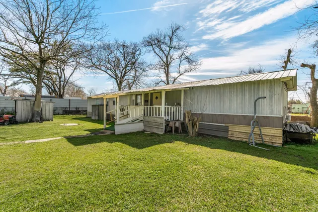 a view of a house with swimming pool and a yard