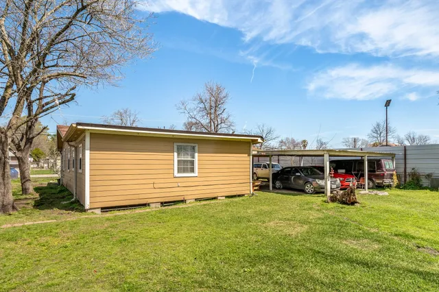 a view of a house with a yard and sitting area