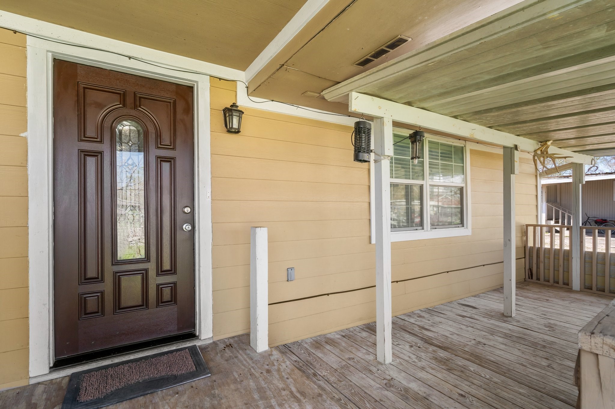230 Busch Street Houston, TX 77060 - Photo 6 of 34 a view of a porch with wooden floor and front door