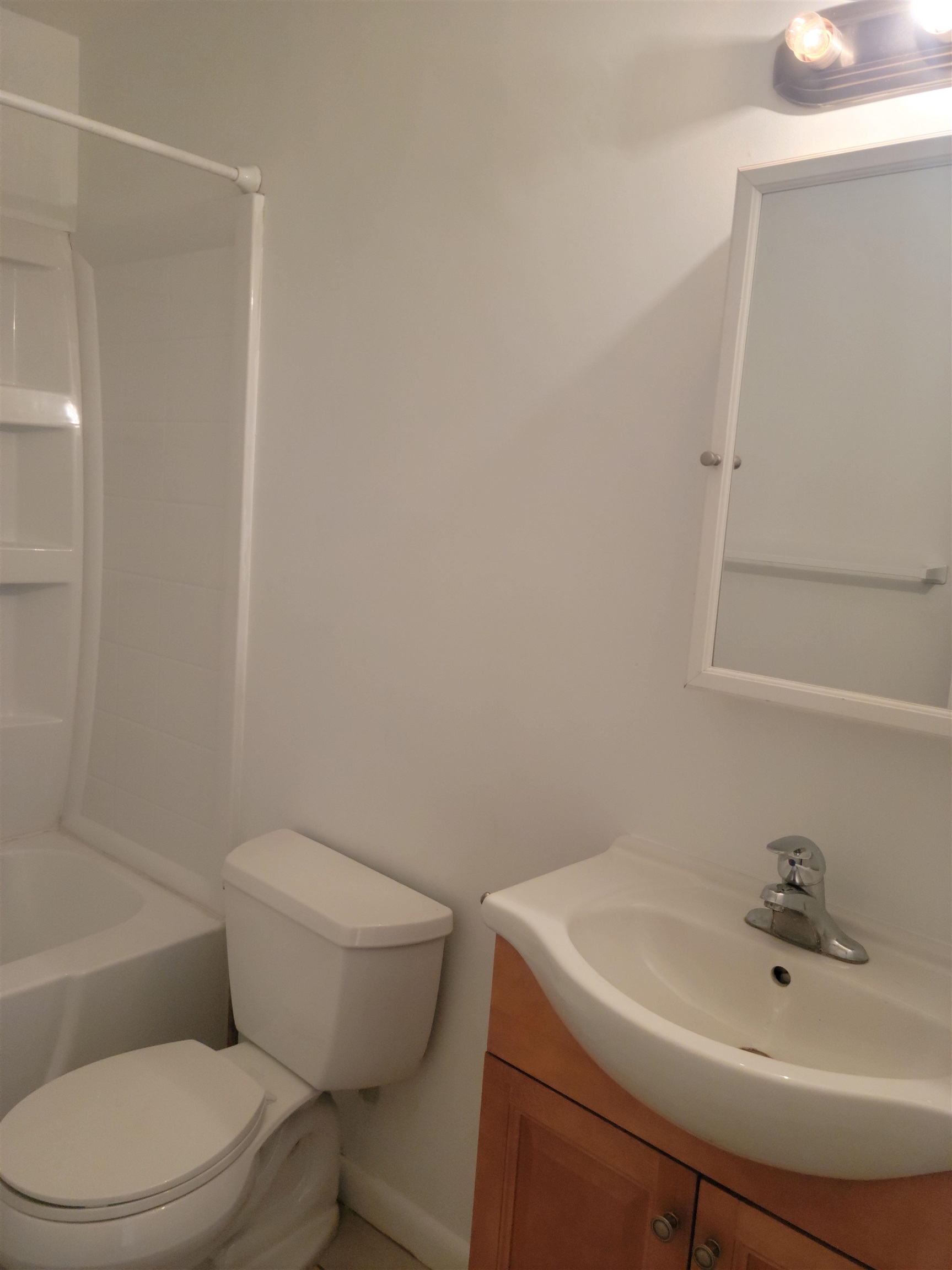 2605 Dobbs Road, Unit D St. Augustine, FL 32086 - Photo 10 of 13 a white toilet sitting next to a bathroom sink