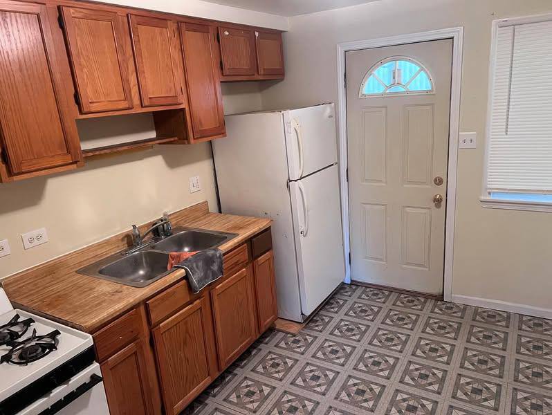 3133 48th Court, Unit 2W Cicero, IL 60804 - Photo 6 of 10 a kitchen with a stove and a refrigerator