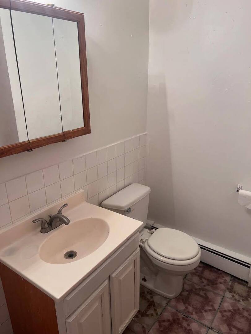 3133 48th Court, Unit 2W Cicero, IL 60804 - Photo 8 of 10 a white toilet sitting next to a white sink