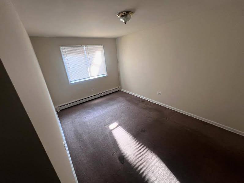 3133 48th Court, Unit 2W Cicero, IL 60804 - Photo 10 of 10 an empty room with wooden floor and windows