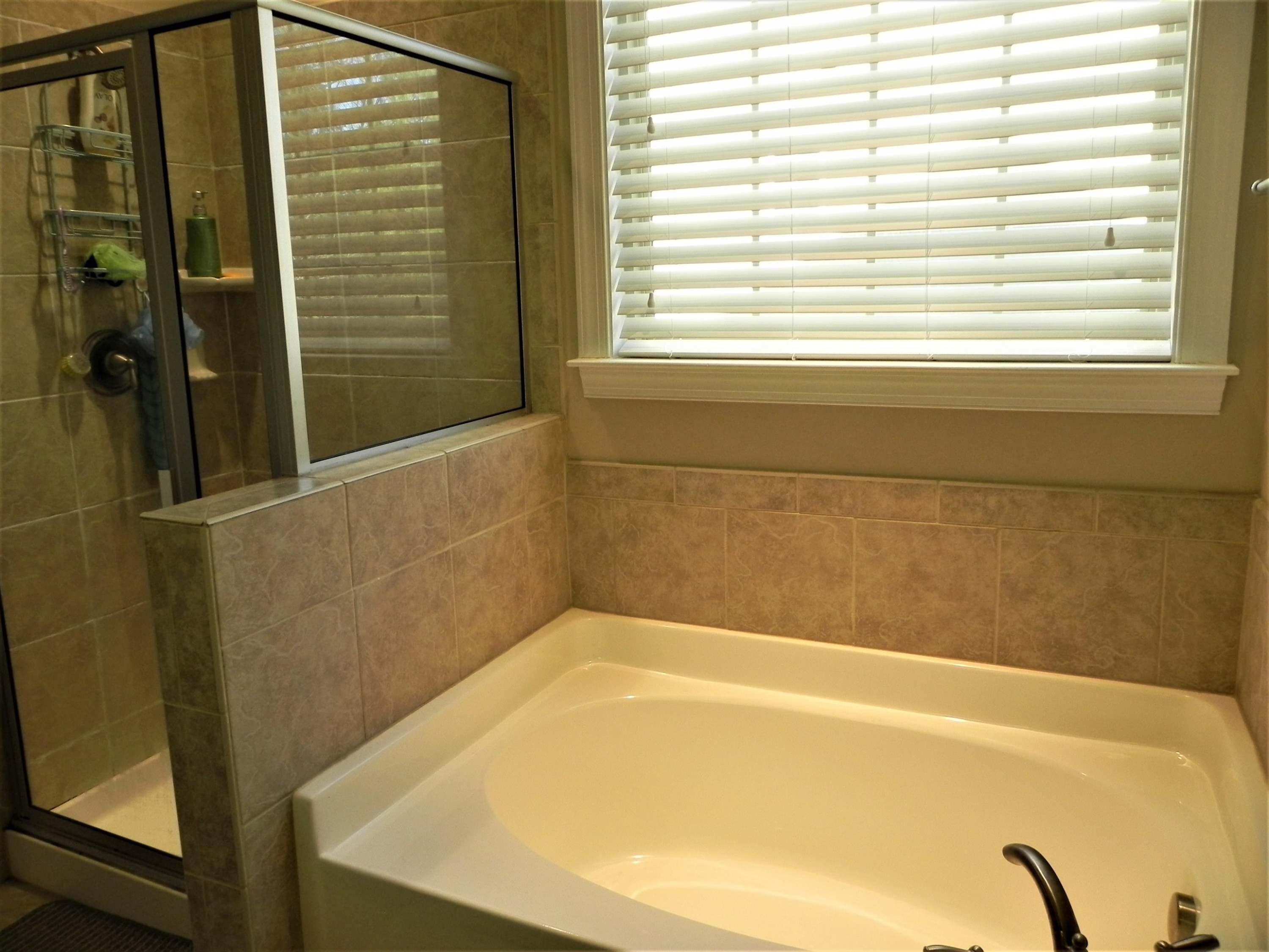 2129 Lower Lake Road Wake Forest, NC 27587 - Photo 21 of 41 Soak in the Garden Tub or Clean Up Quickly in the Tiled Shower Primary En Suite