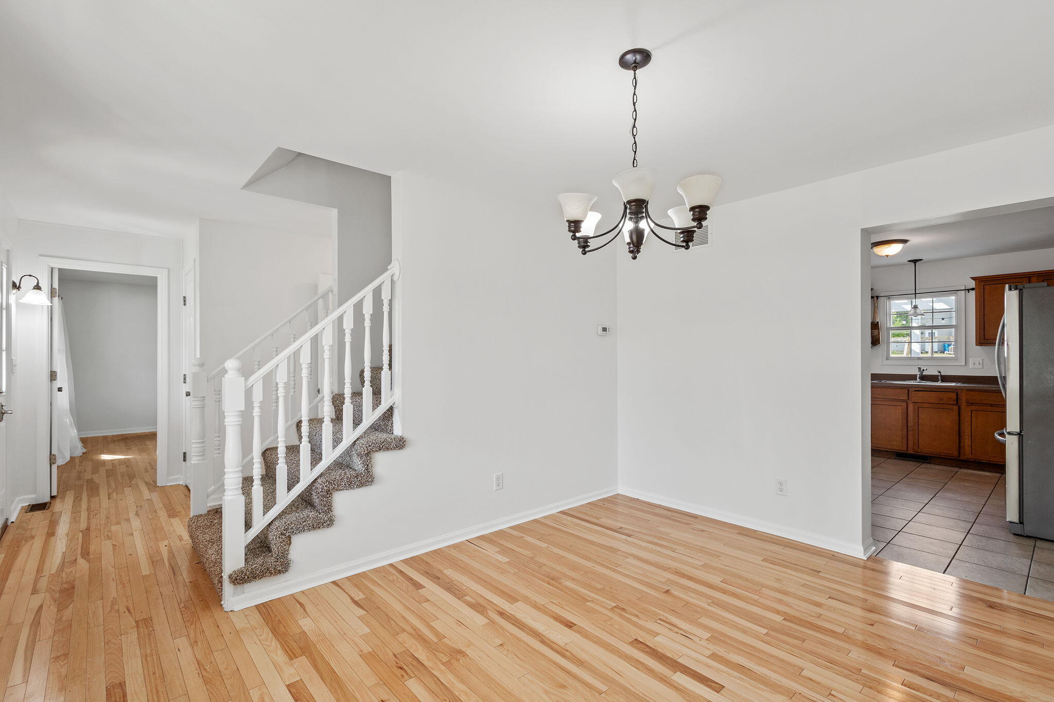 1741 East 106th Place Crown Point, IN 46307 - Photo 2 of 34 a view of a room with wooden floor and stairs