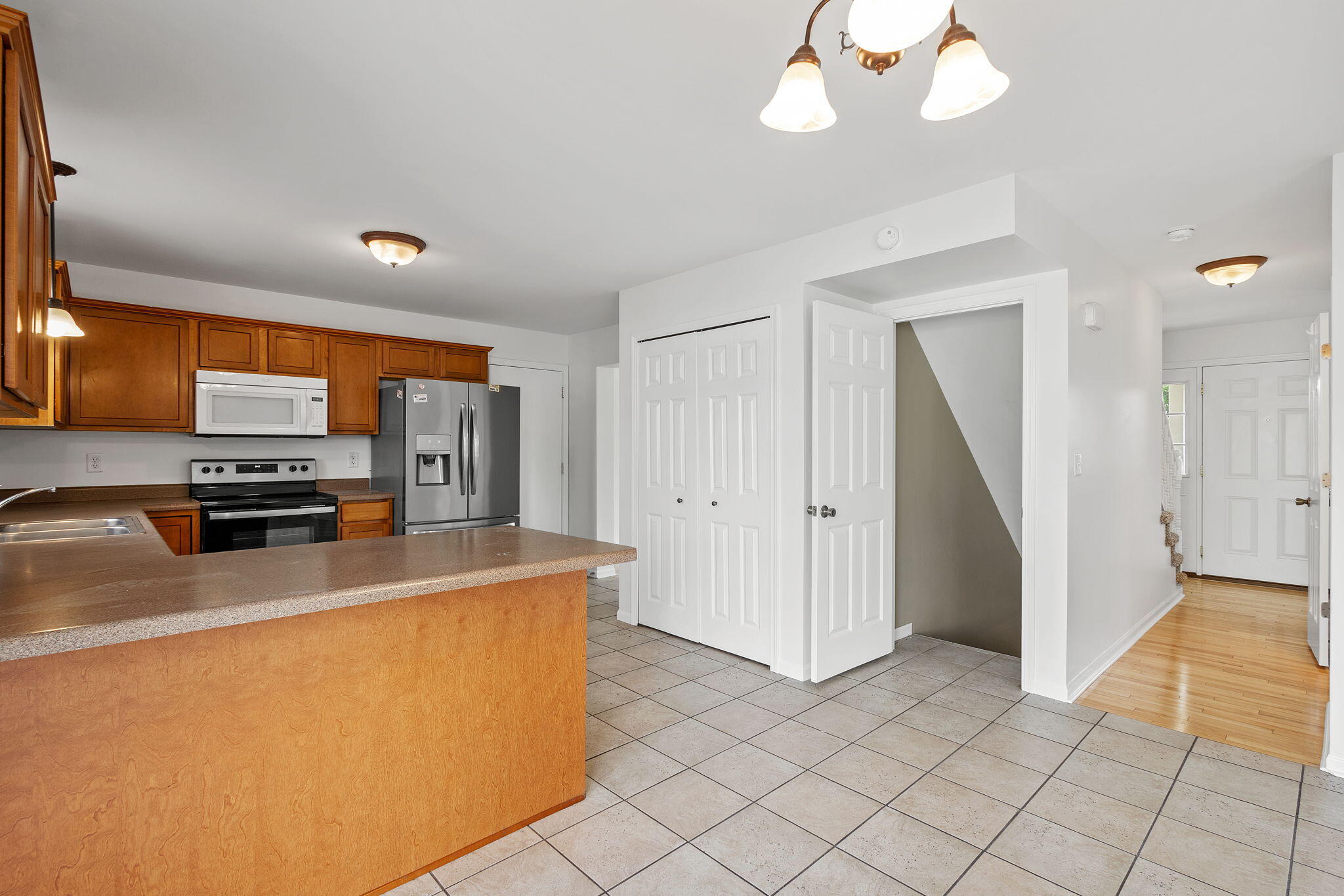 1741 East 106th Place Crown Point, IN 46307 - Photo 8 of 34 a kitchen with stainless steel appliances a refrigerator and a stove top oven