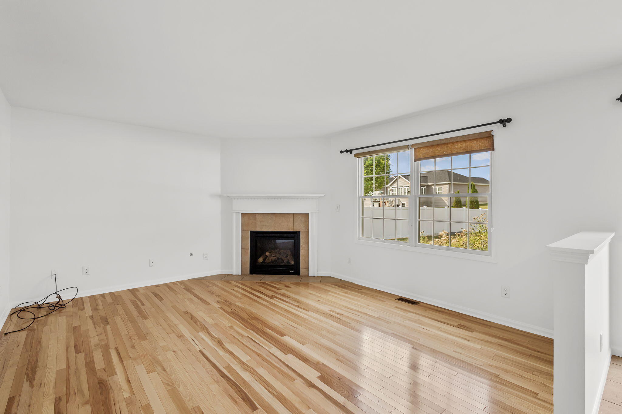 1741 East 106th Place Crown Point, IN 46307 - Photo 9 of 34 a view of an empty room with window and wooden floor