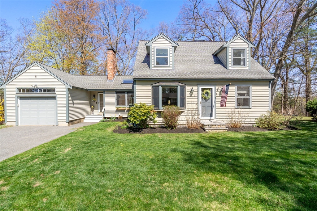 9 Davis Road Hudson, MA 01749 - Photo 1 of 32 a front view of a house with a garden and yard