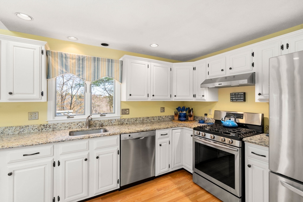 9 Davis Road Hudson, MA 01749 - Photo 13 of 32 a kitchen with granite countertop a sink cabinets stainless steel appliances and a window