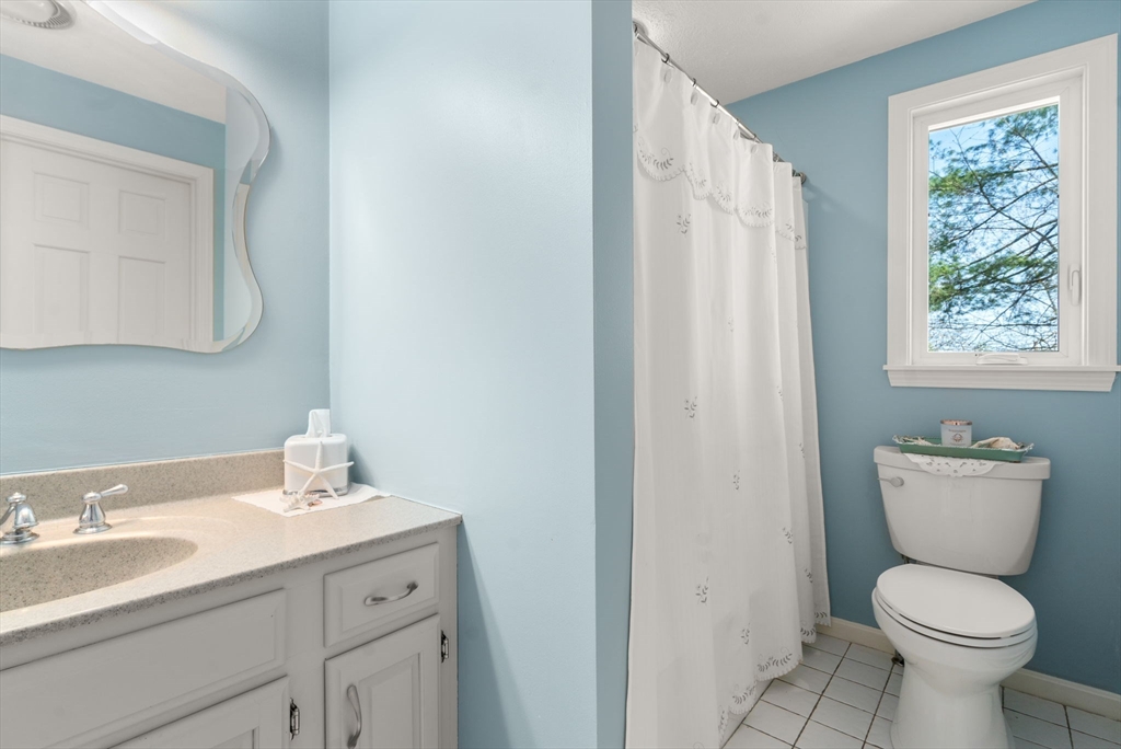 9 Davis Road Hudson, MA 01749 - Photo 20 of 32 a bathroom with a toilet sink and mirror