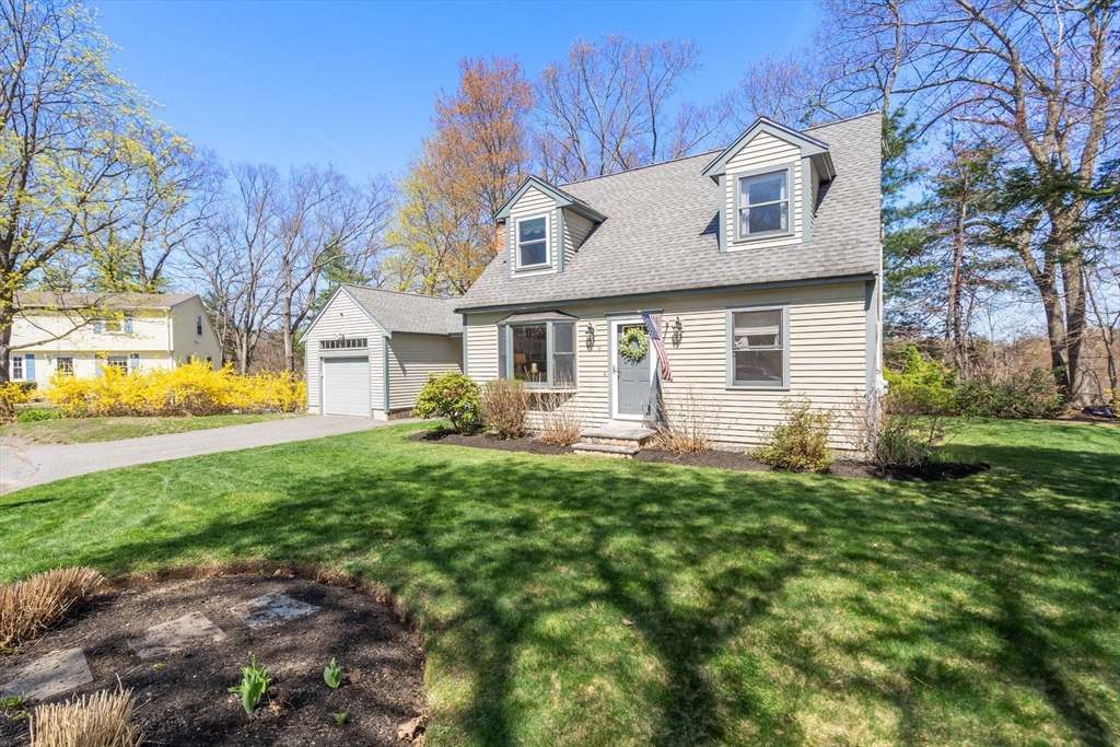 9 Davis Road Hudson, MA 01749 - Photo 2 of 32 a front view of a house with a garden