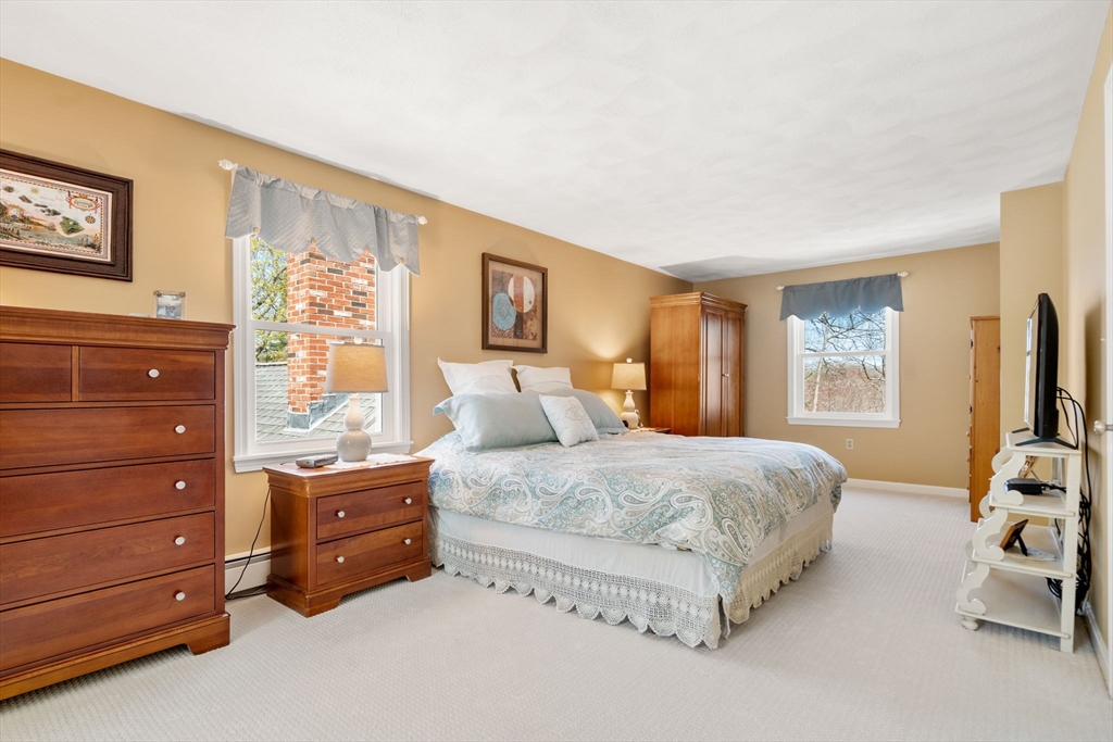 9 Davis Road Hudson, MA 01749 - Photo 23 of 32 a bedroom with a bed and furniture