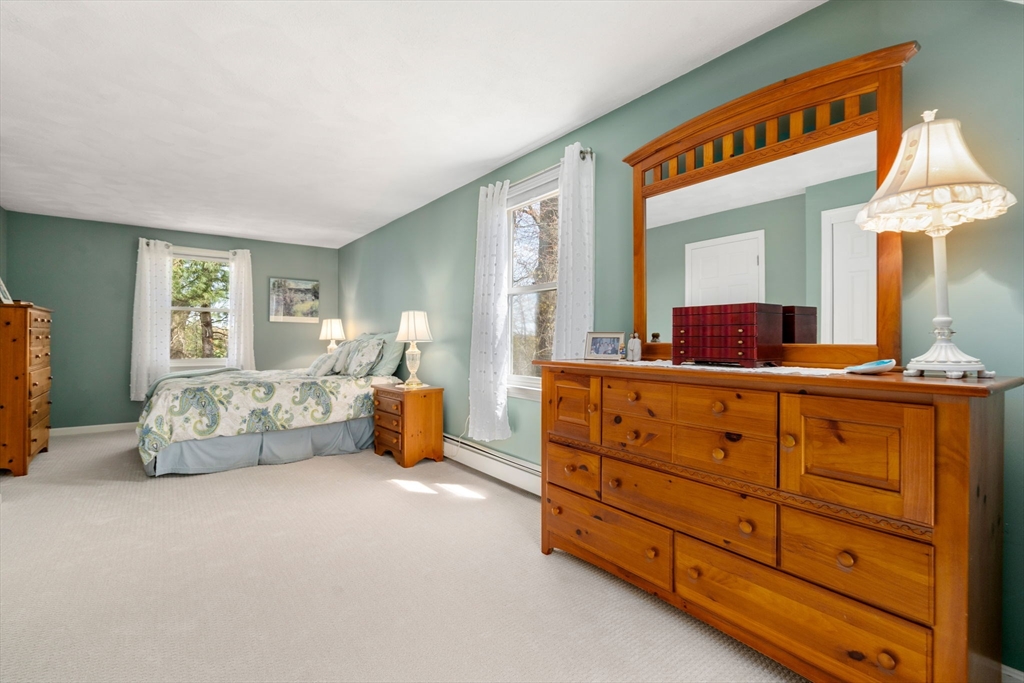 9 Davis Road Hudson, MA 01749 - Photo 25 of 32 a spacious bedroom with a bed and a dresser
