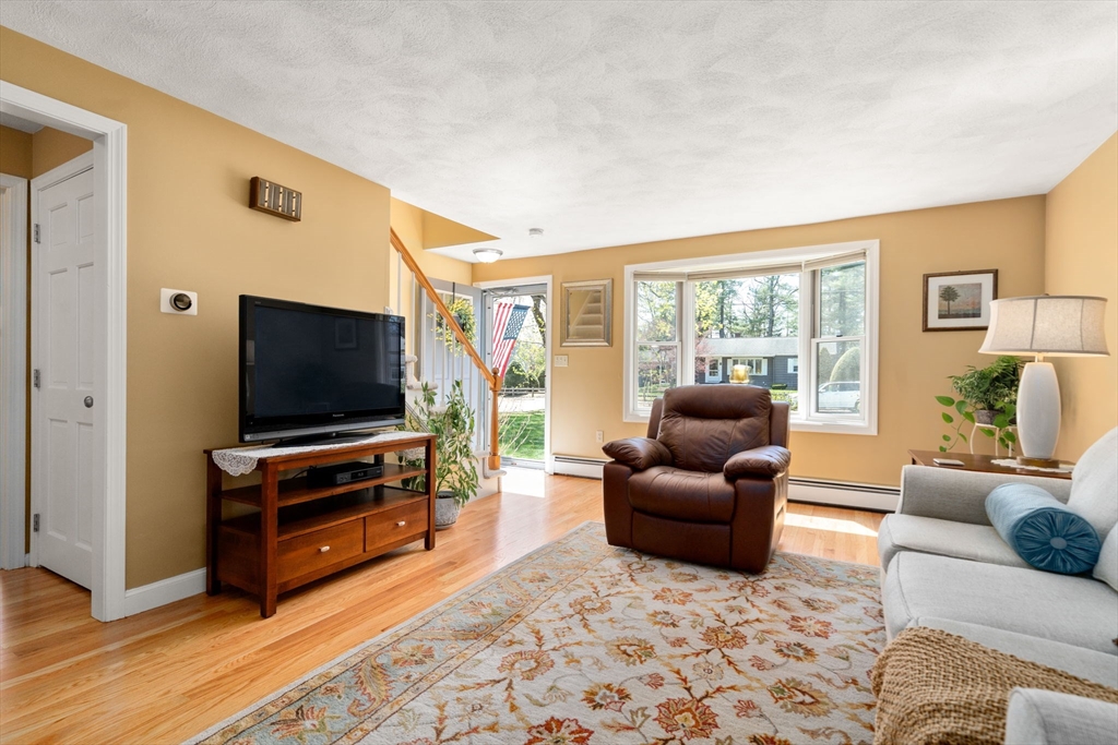 9 Davis Road Hudson, MA 01749 - Photo 4 of 32 a living room with furniture and a flat screen tv