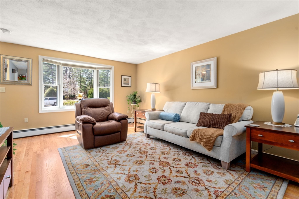 9 Davis Road Hudson, MA 01749 - Photo 5 of 32 a living room with furniture and a lamp