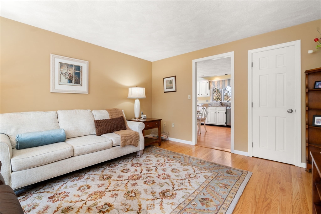 9 Davis Road Hudson, MA 01749 - Photo 6 of 32 a living room with furniture and a wooden floor