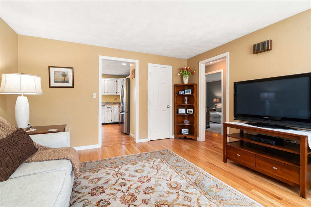 9 Davis Road Hudson, MA 01749 - Photo 7 of 32 a living room with furniture and a flat screen tv
