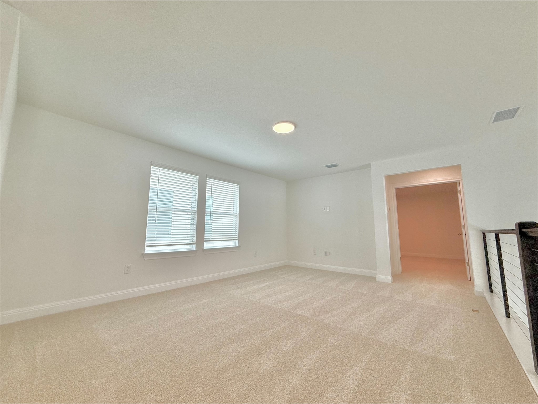 405 Young Street Buda, TX 78610 - Photo 11 of 25 an empty room with windows and closet