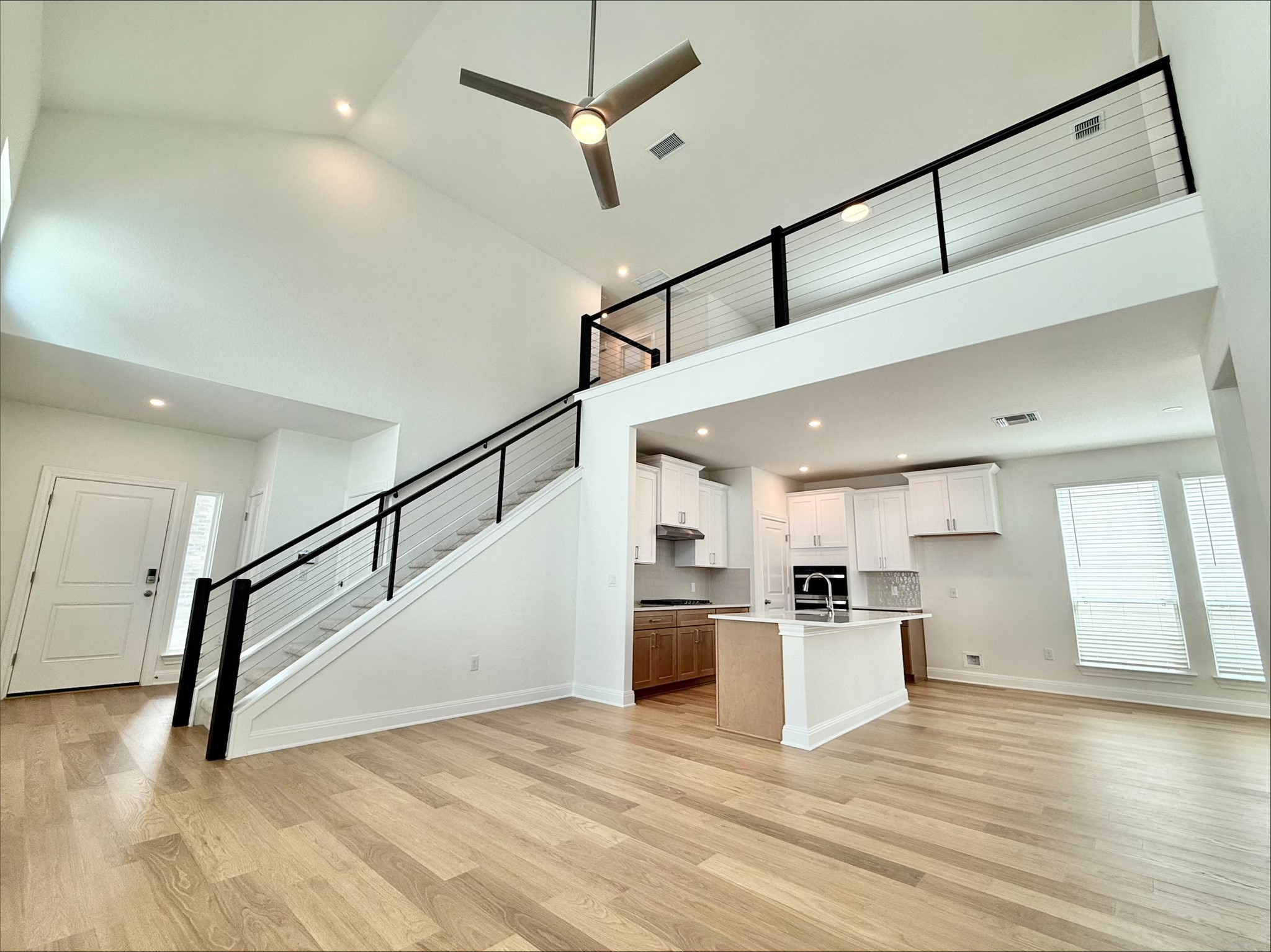 405 Young Street Buda, TX 78610 - Photo 2 of 25 a view of a kitchen with a sink and a refrigerator