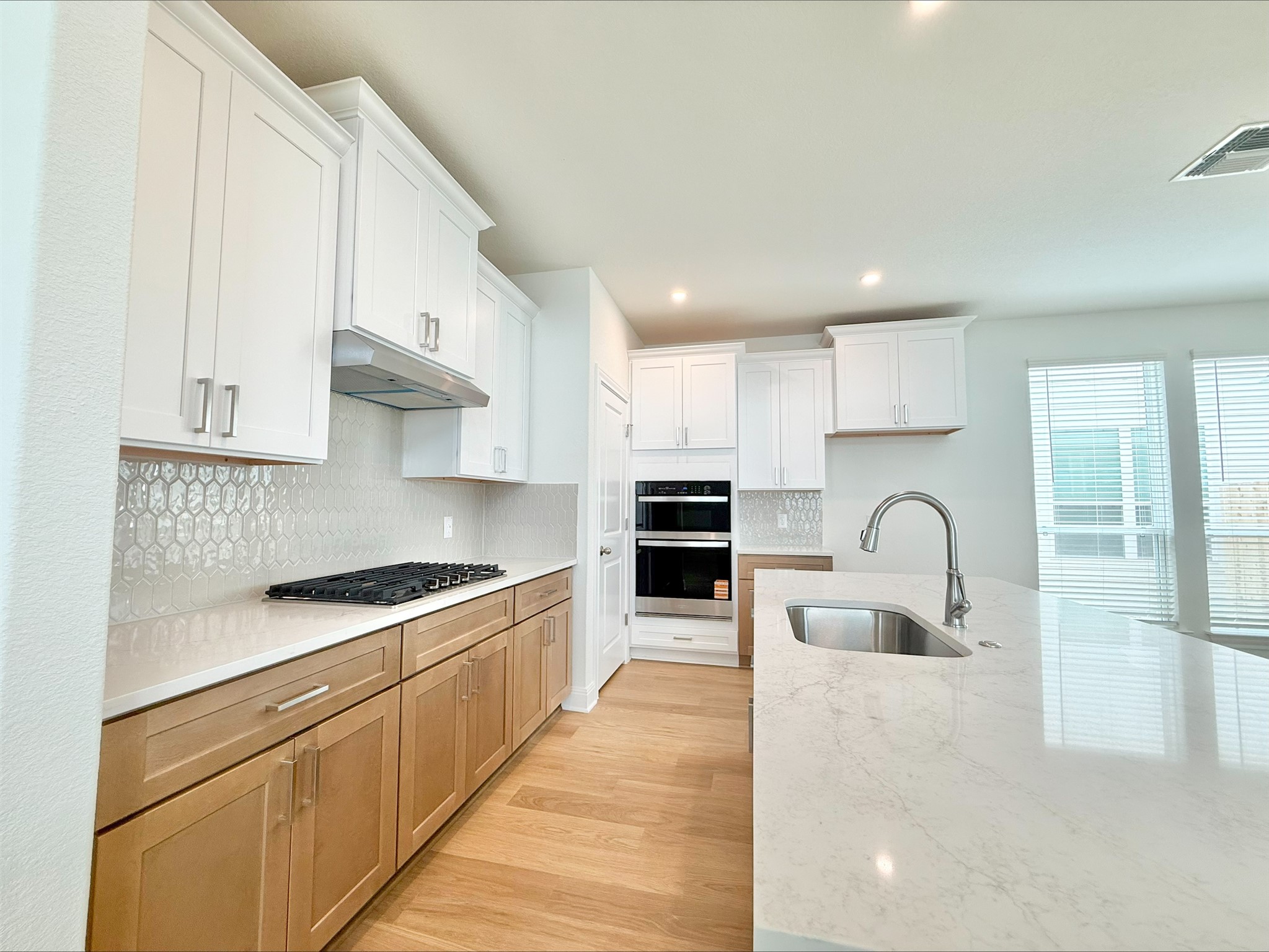 405 Young Street Buda, TX 78610 - Photo 5 of 25 a kitchen with stainless steel appliances granite countertop a sink stove and cabinets