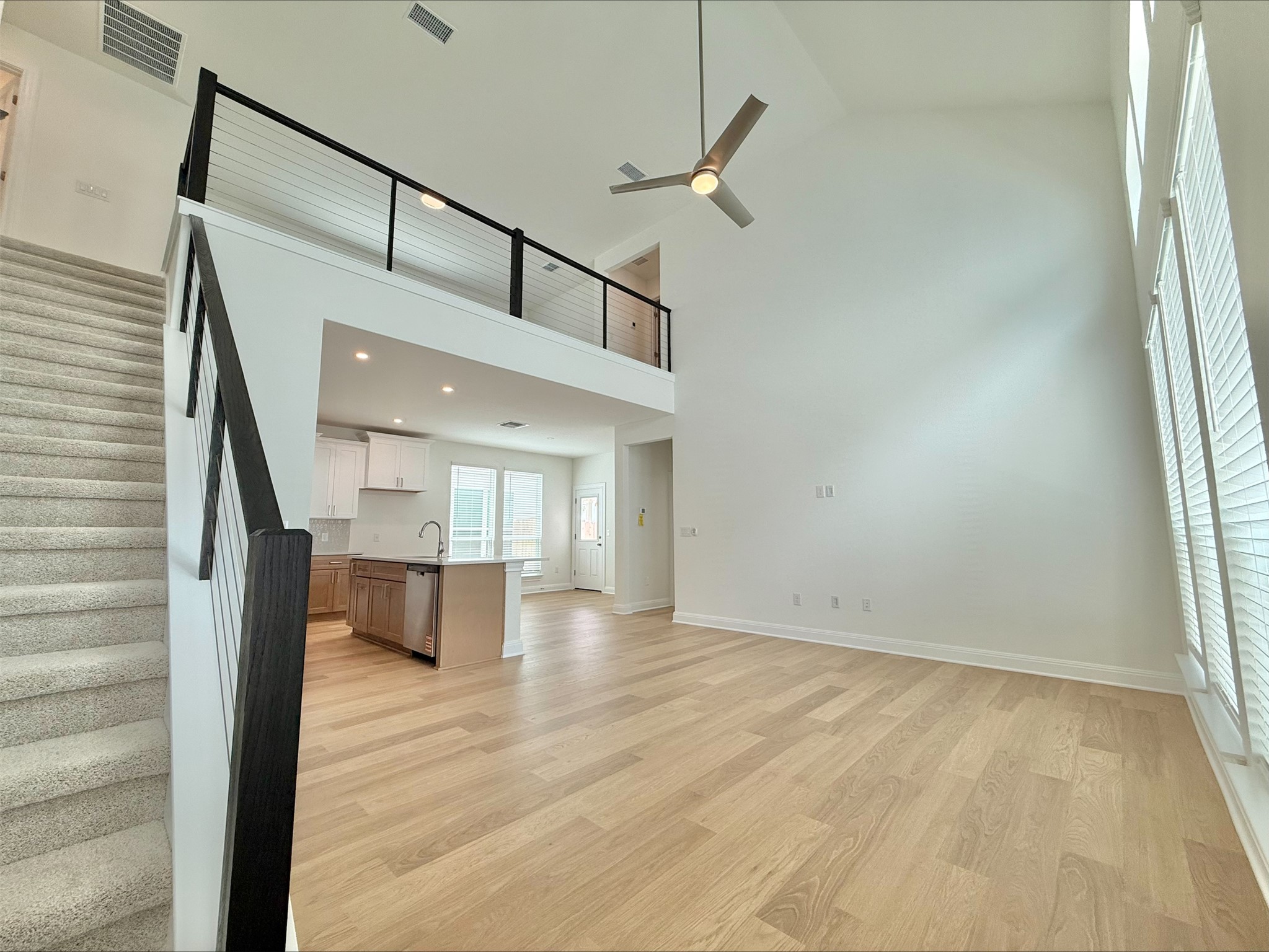 405 Young Street Buda, TX 78610 - Photo 6 of 25 a view of empty room with stairs and wooden floor