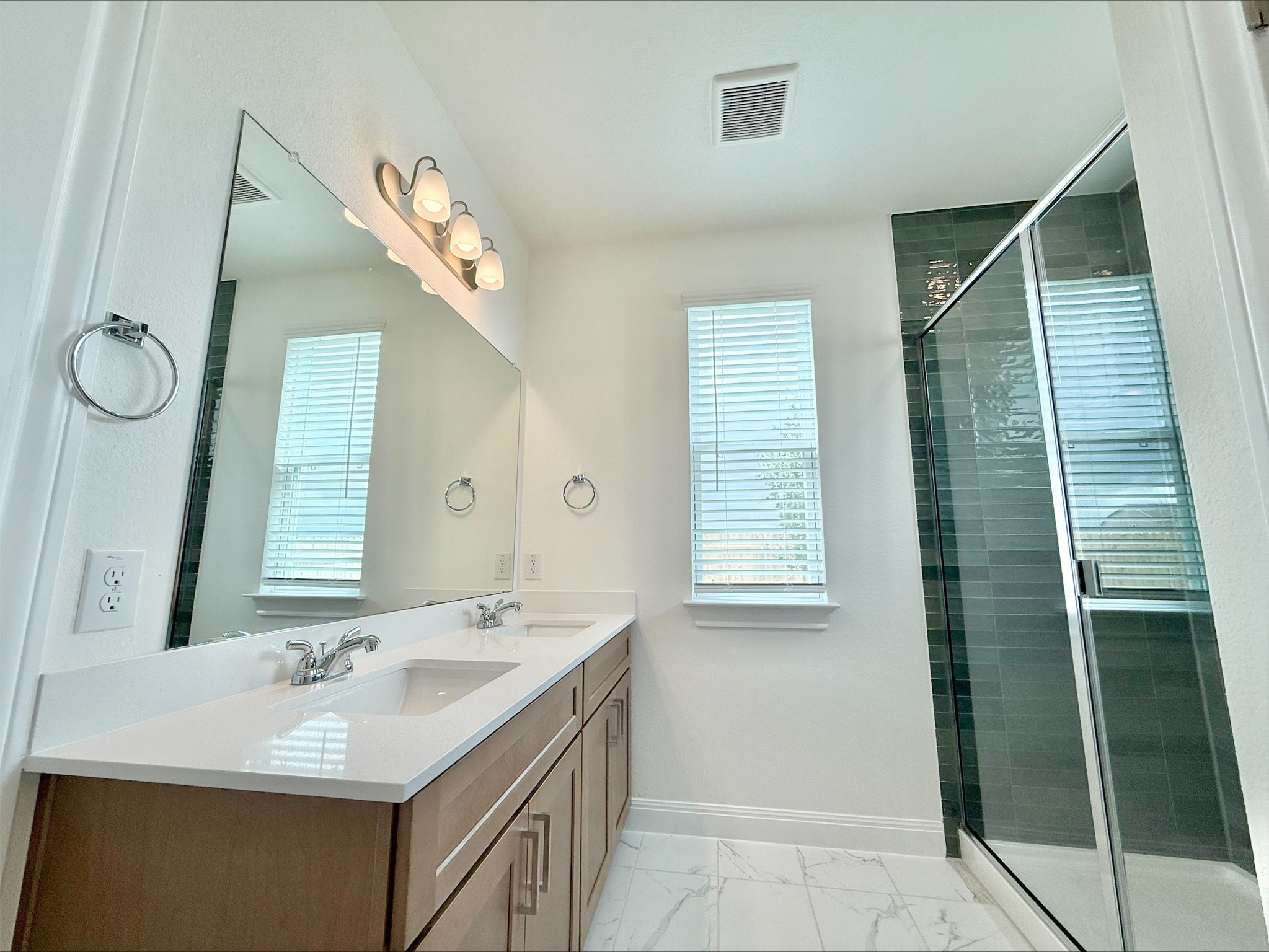405 Young Street Buda, TX 78610 - Photo 9 of 25 a bathroom with a sink and a mirror