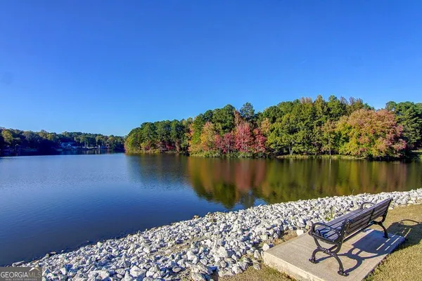 a view of a lake with sitting area and lake view
