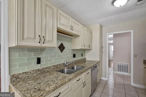 a kitchen with stainless steel appliances granite countertop a sink stove and cabinets