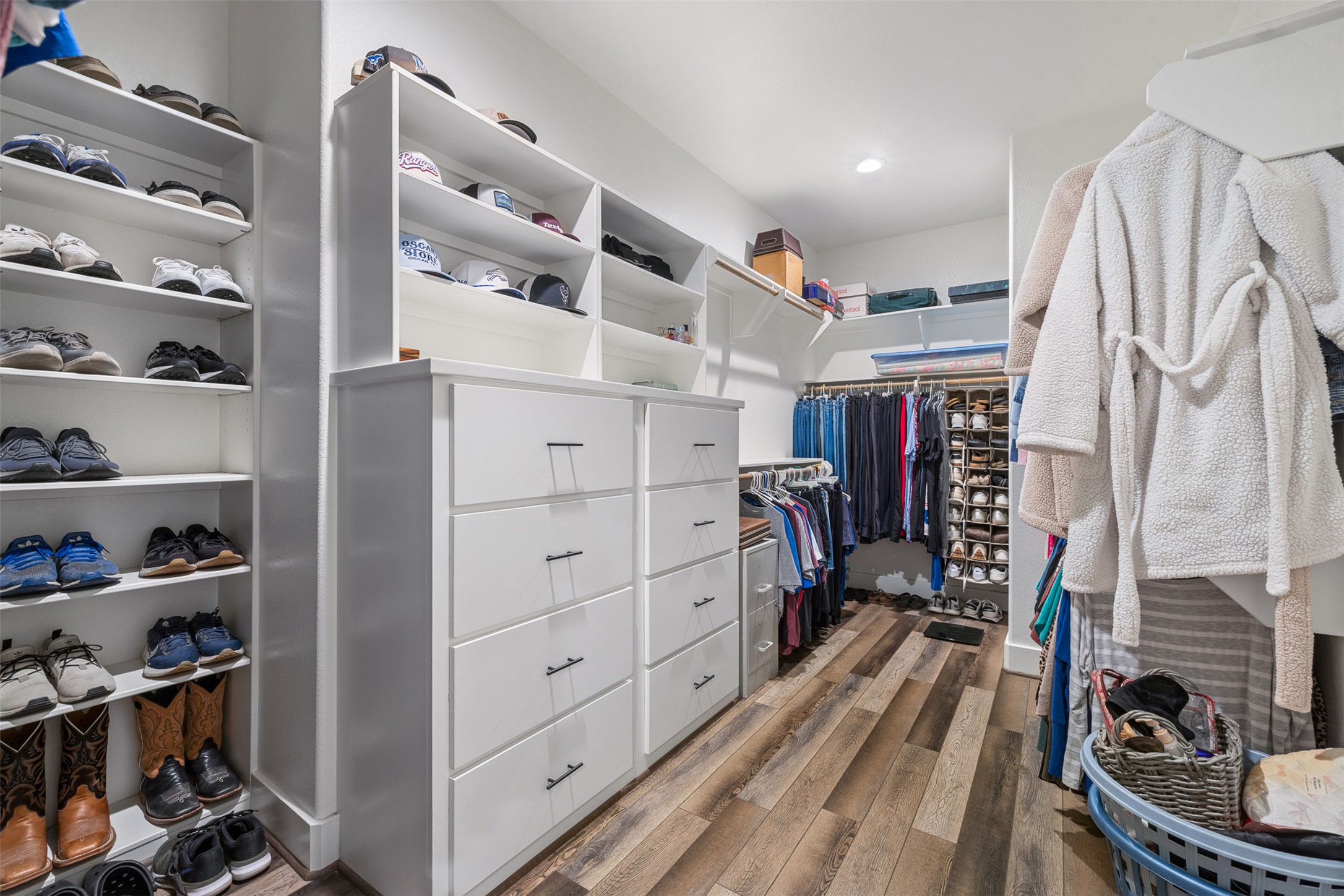 1306 22 Hills Road Gause, TX 77857 - Photo 3 of 40 Custom closet system featuring wood-finish flooring, built-in shelving, ample drawer storage, and dedicated hanging rods
