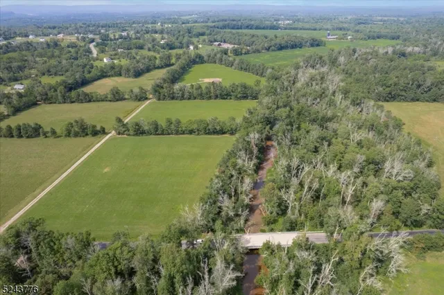 an aerial view of field with beach