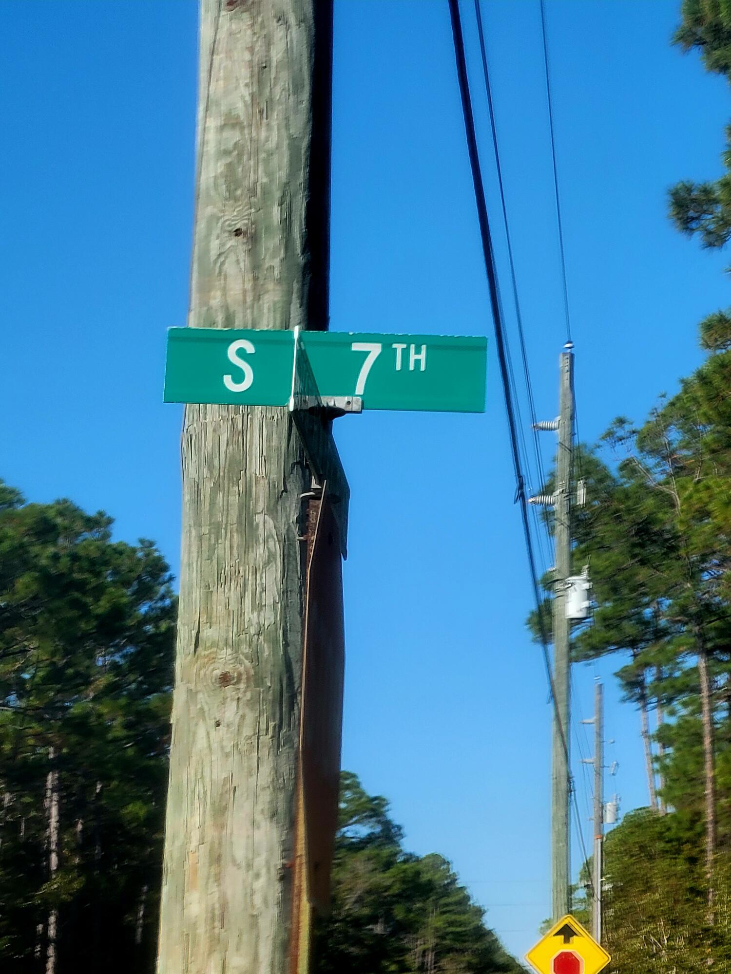 10-15 Chat Holly Road Santa Rosa Beach, FL 32459 - Photo 2 of 6 a green field with trees in front of it