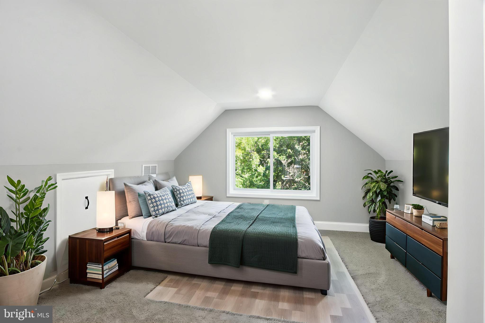 310 Audrey Avenue Baltimore, MD 21225 - Photo 16 of 35 a spacious bedroom with a large bed and a potted plant