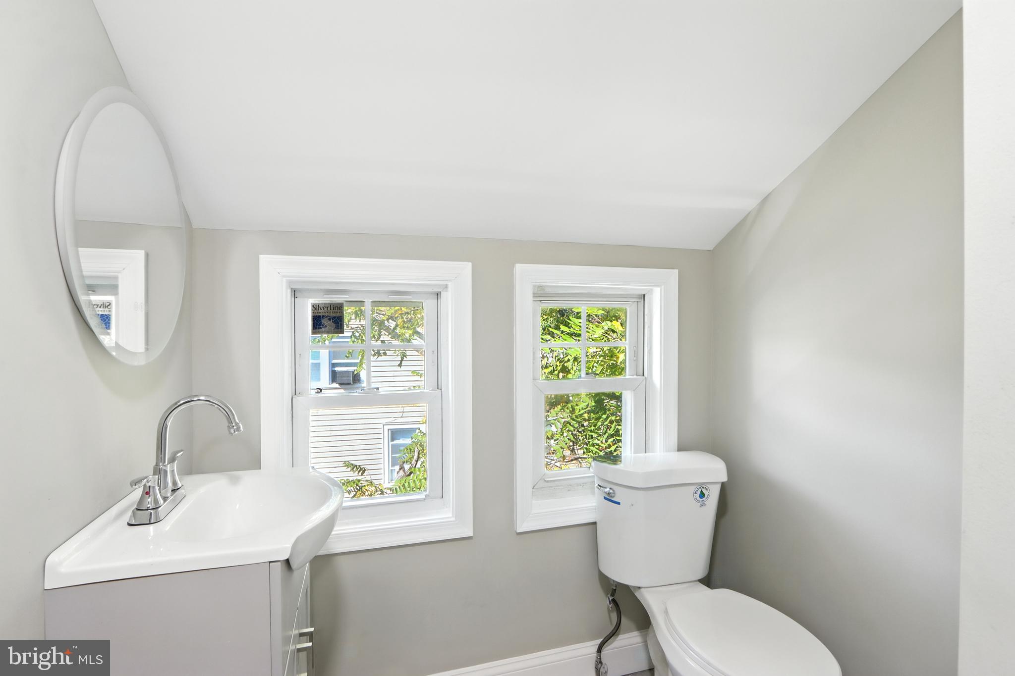 310 Audrey Avenue Baltimore, MD 21225 - Photo 18 of 35 a bathroom with a toilet sink and mirror