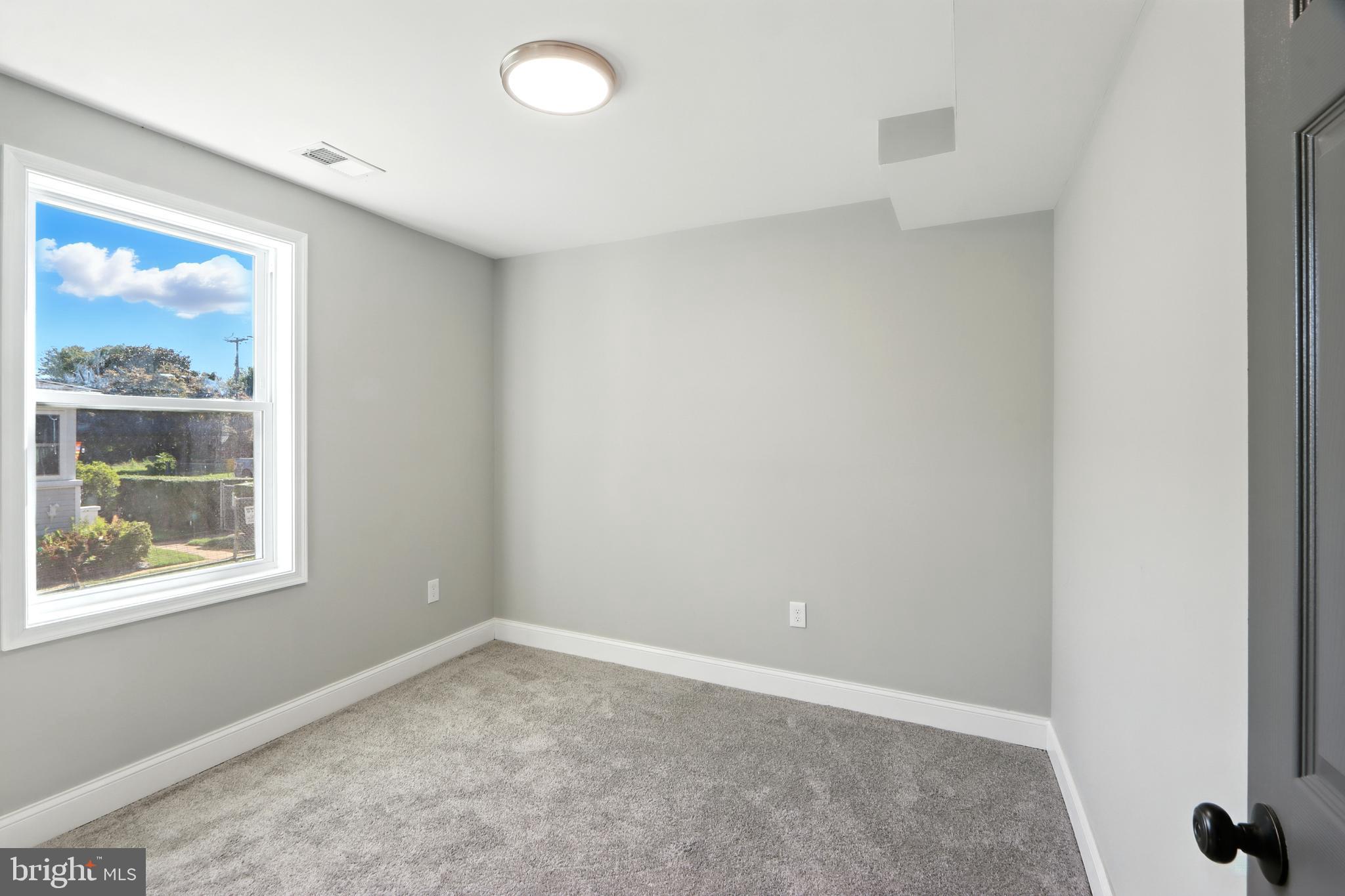 310 Audrey Avenue Baltimore, MD 21225 - Photo 21 of 35 an empty room with a window
