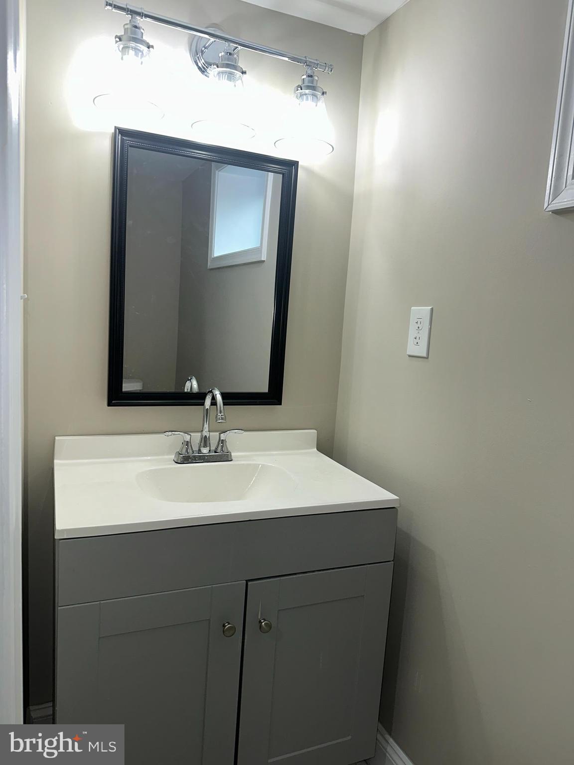 310 Audrey Avenue Baltimore, MD 21225 - Photo 29 of 35 a bathroom with a sink and a mirror