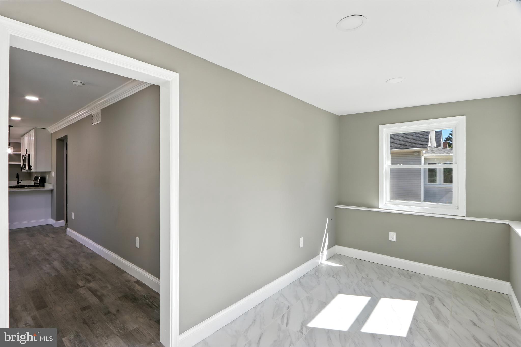 310 Audrey Avenue Baltimore, MD 21225 - Photo 4 of 35 an empty room with windows