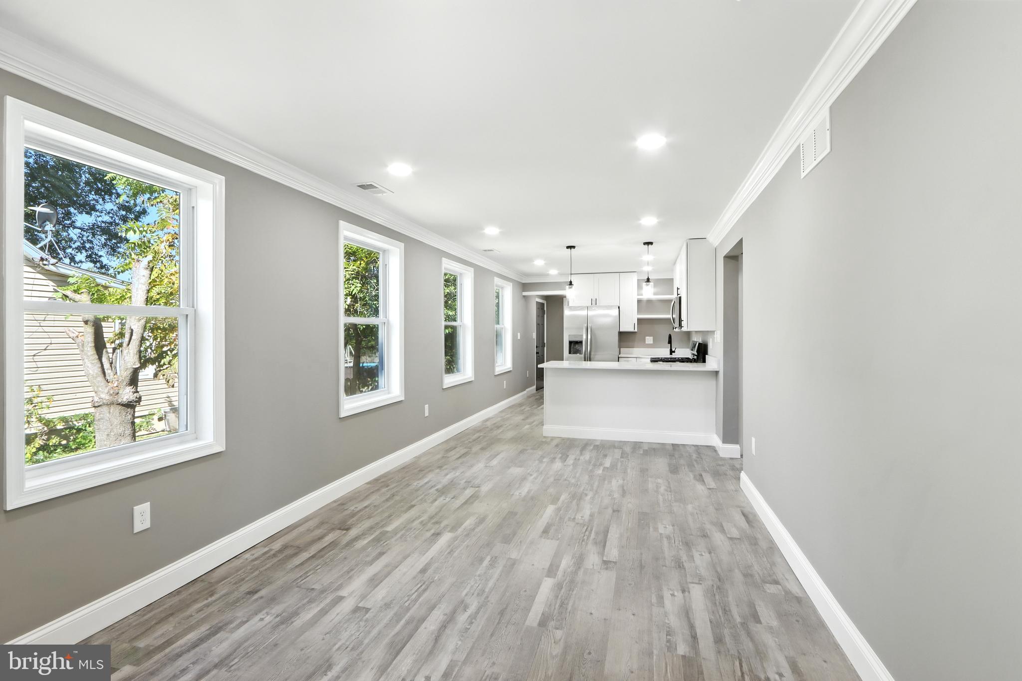 310 Audrey Avenue Baltimore, MD 21225 - Photo 6 of 35 a view of a kitchen with wooden floor and windows