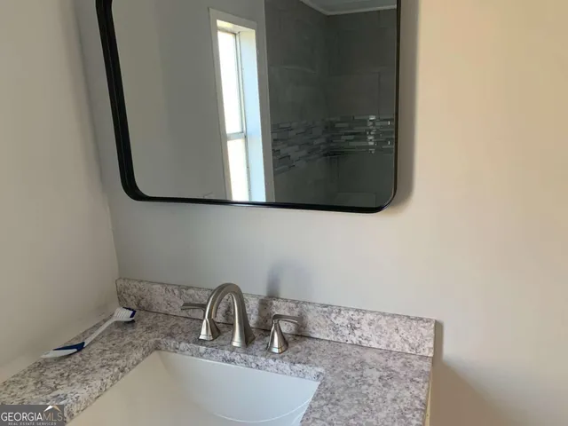 a bathroom with a sink and a mirror