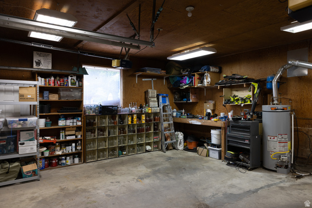 827 South 600 East Logan, UT 84321 - Photo 25 of 30 Garage space with concrete flooring, wood paneling, and fluorescent overhead lighting