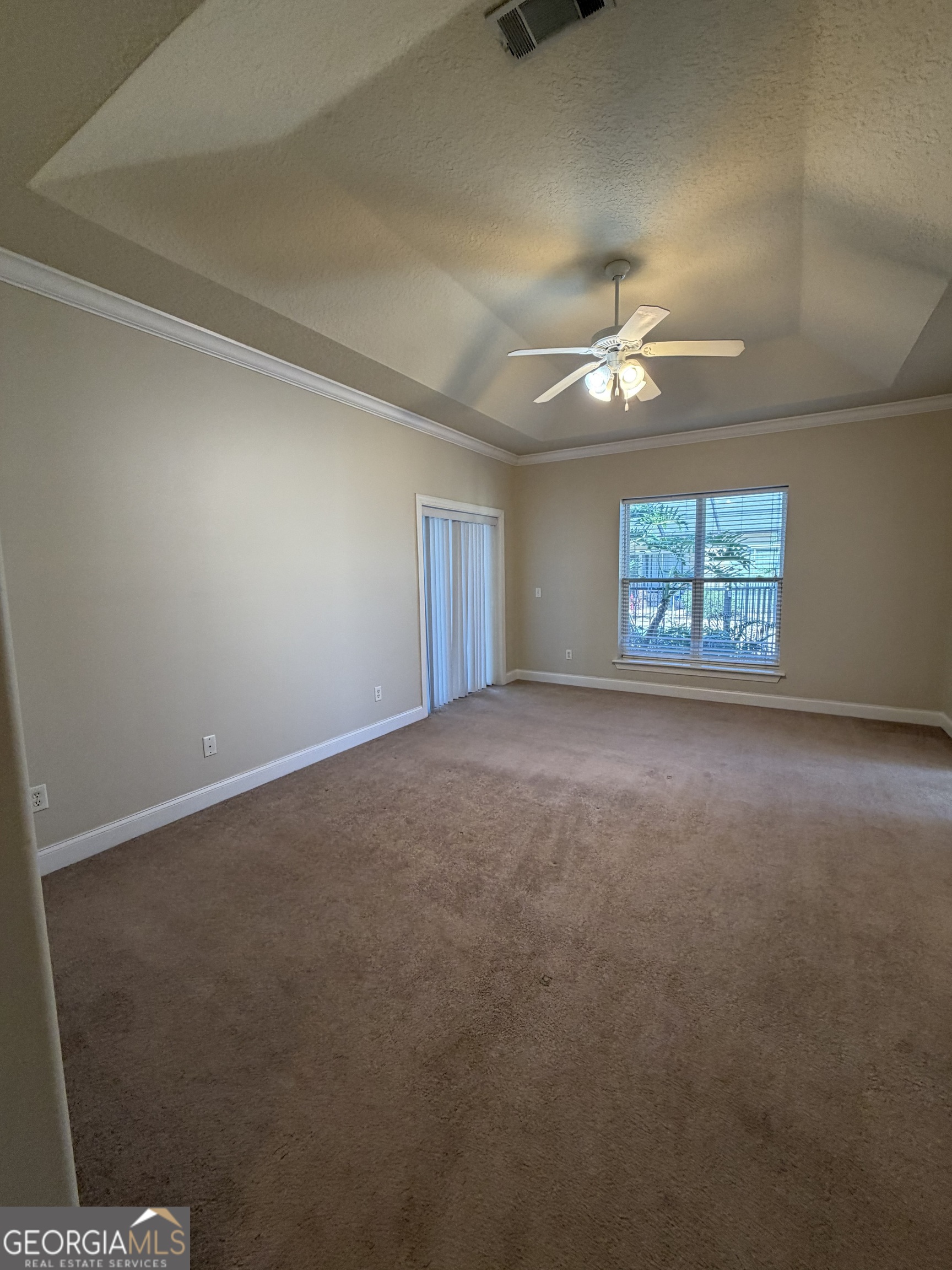 36 Coastal Walk St. Marys, GA 31558 - Photo 13 of 40 an empty room with windows and ceiling fan view