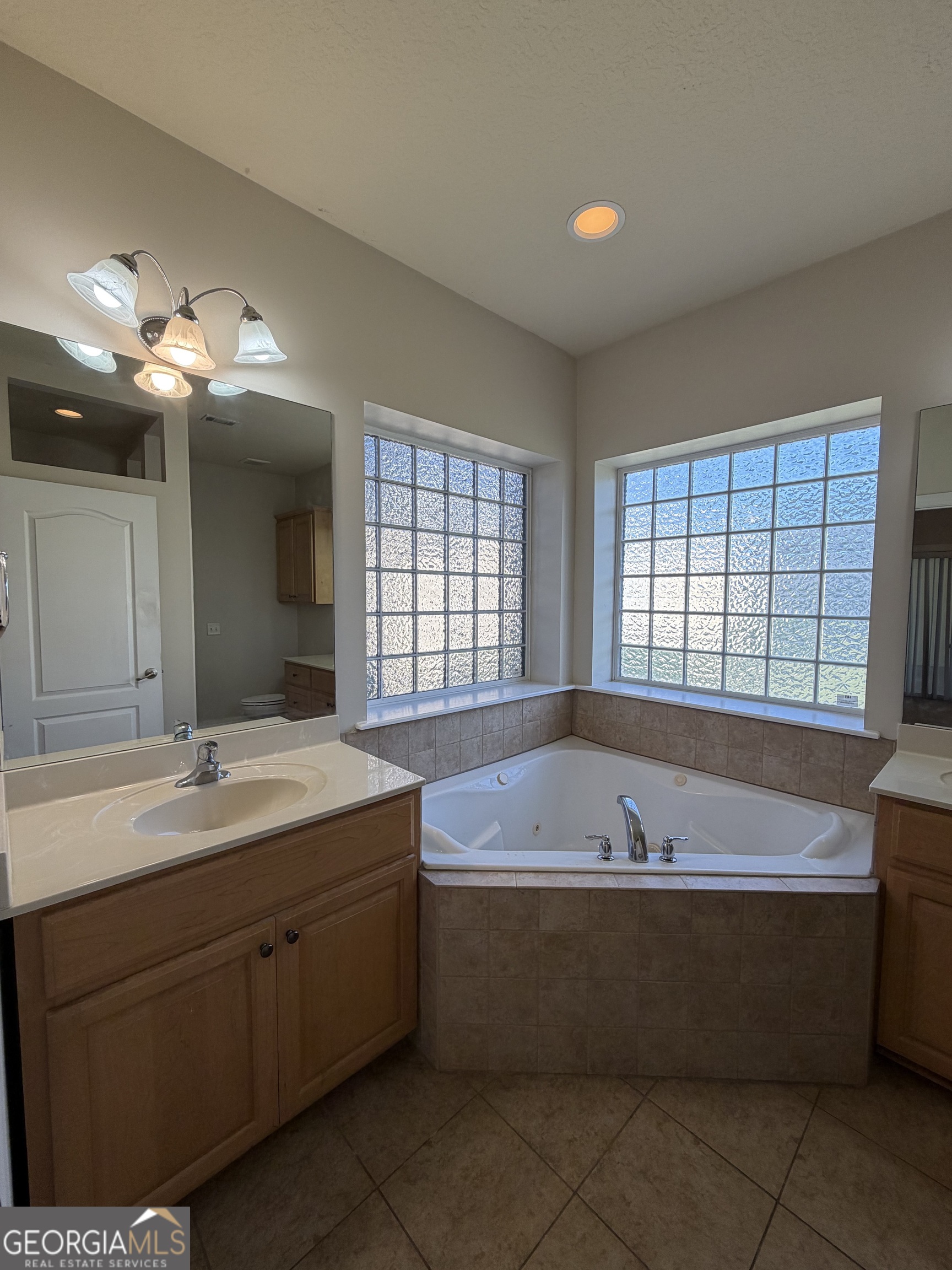36 Coastal Walk St. Marys, GA 31558 - Photo 18 of 40 a spacious bathroom with a tub sink and mirror