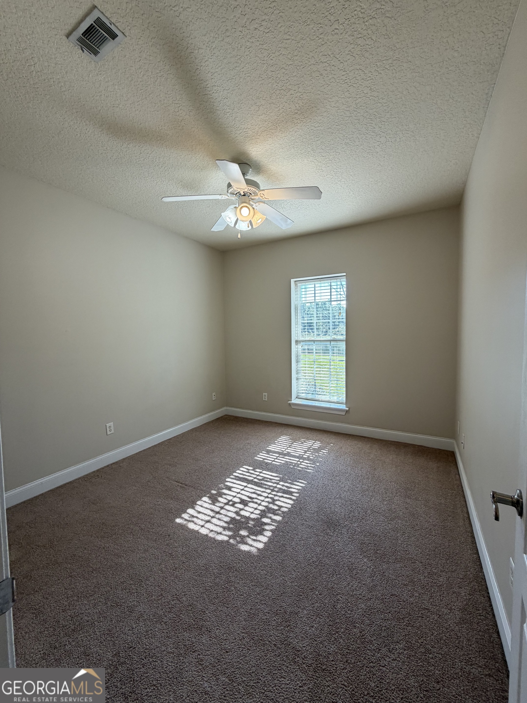 36 Coastal Walk St. Marys, GA 31558 - Photo 22 of 40 an empty room with windows and fan